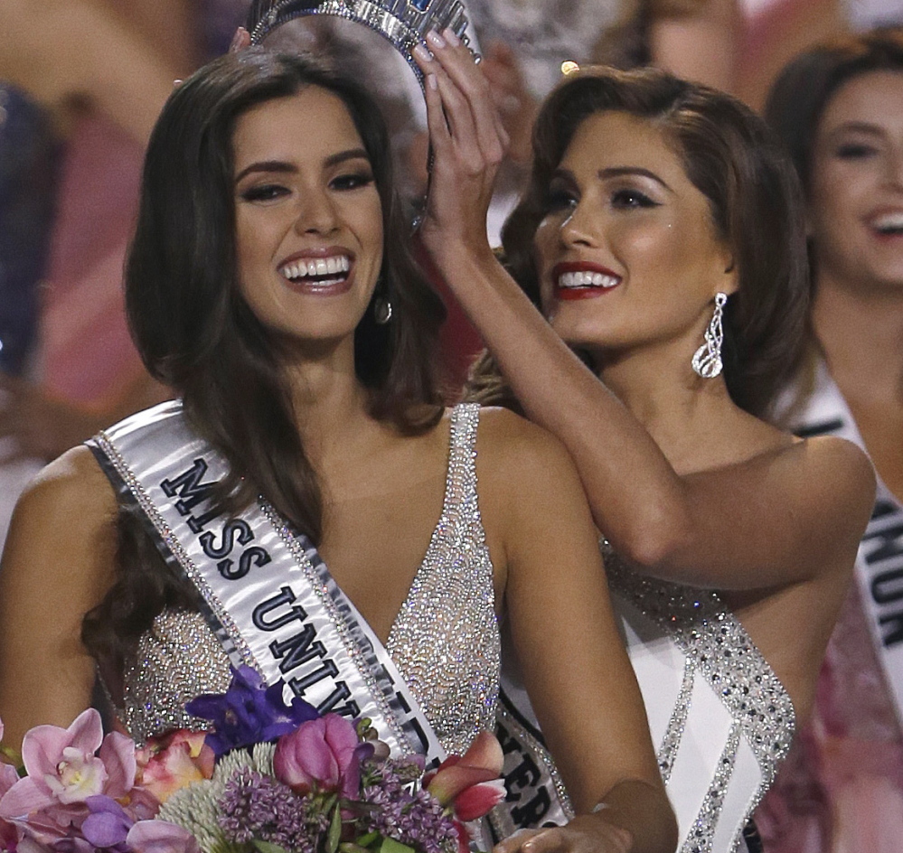 Reigning Miss Universe Gabriela Isler, right, crowns the new Miss Universe, Paulina Vega of Colombia, at the pageant in January.