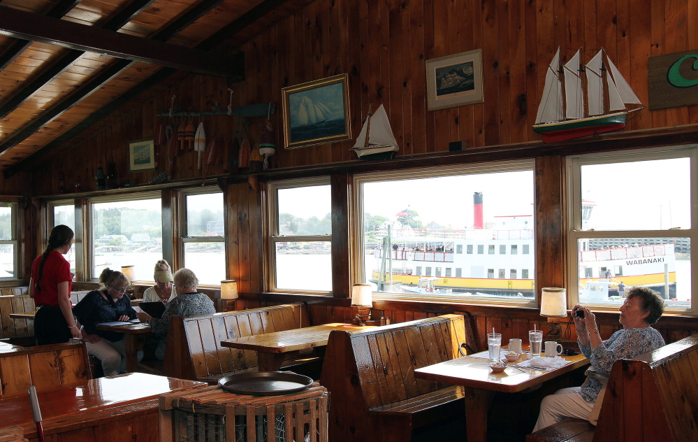 A Casco Bay Line ferry sits outside Cook’s Lobster House in Harpswell. Jen Charboneau, the new co-owner of the restaurant, plans to “make what’s there a little bit better.”