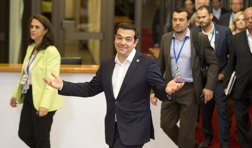 Greek Prime Minister Alexis Tsipras, center, leaves after an emergency meeting of eurozone heads of state or government in Brussels on Tuesday. The eurozone leaders gave Tsipras a Sunday deadline to come up with a viable proposal to save his country from financial ruin.