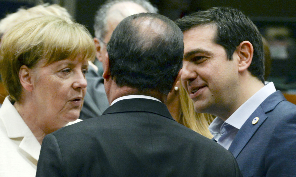 German Chancellor Angela Merkel speaks with French President Francois Hollande, center, and Greek Prime Minister Alexis Tsipras during a meeting of eurozone heads of state at the EU Council building in Brussels on Sunday.
