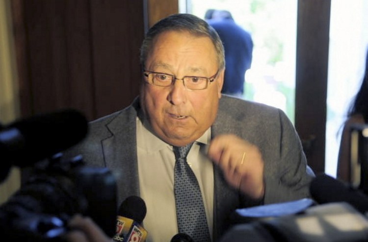 Gov. Paul LePage talks to a reporter about his veto messages as he leaves the State House on July 16. He indicated in interviews before the Supreme Judicial Court ruling that he will not enforce the 65 laws and would seek additional relief in court to block their implementation. 
Joe Phelan/Kennebec Journal