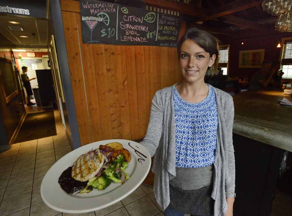 KENNEBUNKPORT, ME - JULY 14: Server Ashleigh Hamilton shows off cumin grilled swordfish with Maine blueberry barbecue sauce, crispy yukons and lemon braised broccoli at Bandaloop in Kennebunkport, Tuesday, July 14, 2015. (Photo by Shawn Patrick Ouellette/Staff Photographer)