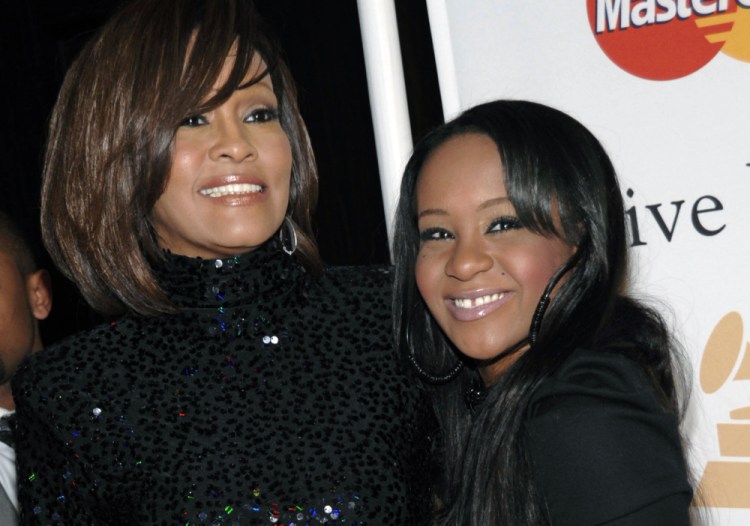 Whitney Houston, left, and daughter Bobbi Kristina Brown in 2011. Brown, who was in hospice after months of receiving medical care, died Sunday.