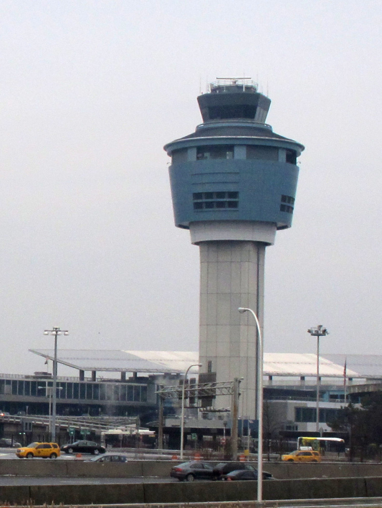 A control tower stands above cramped, outdated, high-traffic LaGuardia Airport in New York.