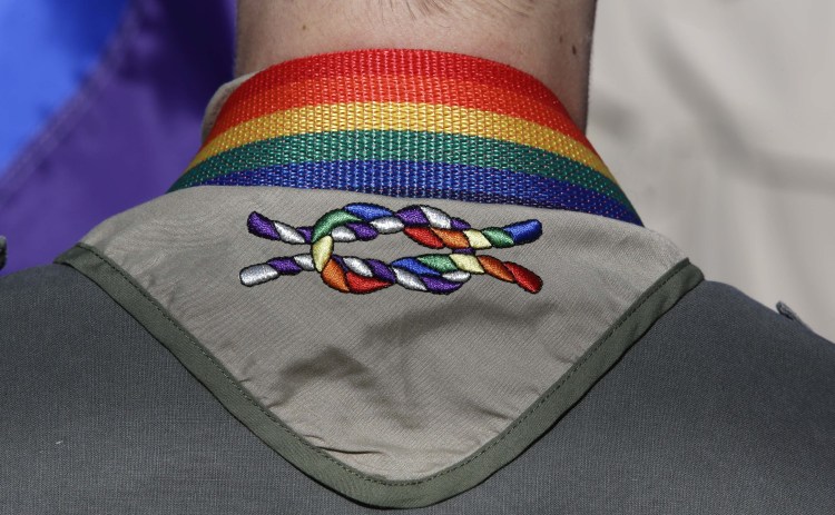 A Boy Scout wears his kerchief embroidered with a rainbow knot during Salt Lake City's 2014 gay pride parade. The Boy Scouts of America's top policy-making board voted Monday to end its blanket ban on gay adult leaders while allowing church-sponsored Scout units to maintain the exclusion.