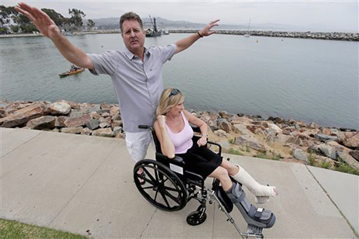 Dirk Frickman describes how the dolphin leaped onto his boat breaking both of his wife Chrissie's ankles. The Associated Press