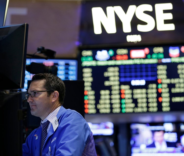 Traders work on the floor at the New York Stock Exchange in New York, Wednesday. The Associated Press