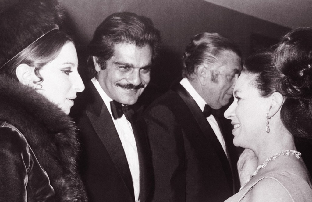 Omar Sharif and singer Barbra Streisand, left, talk with Britain's Princess Margaret at the London premiere of "Funny Girl," on Jan. 15, 1969. The Associated Press