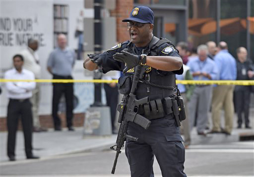 Police near the Washington Navy Yard in Washington tell members of the media to move. A lockdown was underway Thursday morning across the Washington Navy Yard campus after reports of shots fired. The Associated Press