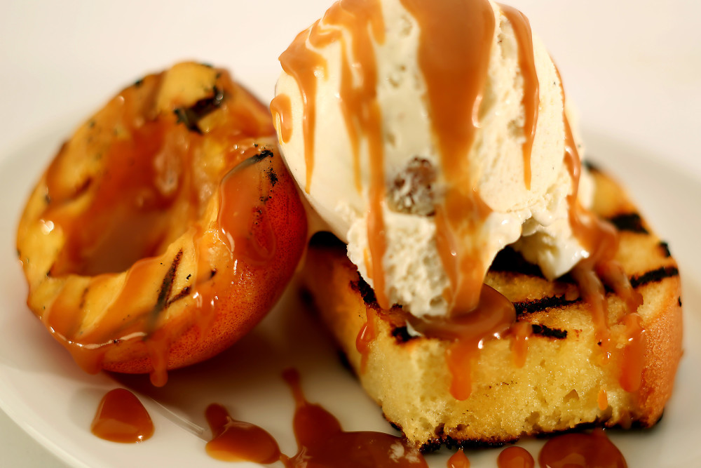 Grilled poundcake with peaches and whisky caramel sauce