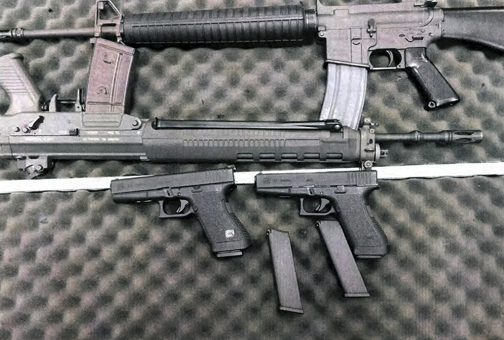 This undated evidence photo shows weapons seized when Alexander Ciccolo was arrested in Adams, Mass. Ciccolo is charged in a federal complaint with possessing firearms after being previously convicted of a felony, and is accused of plotting to commit terrorist acts in support of extremists. U.S. Attorney's Office via AP