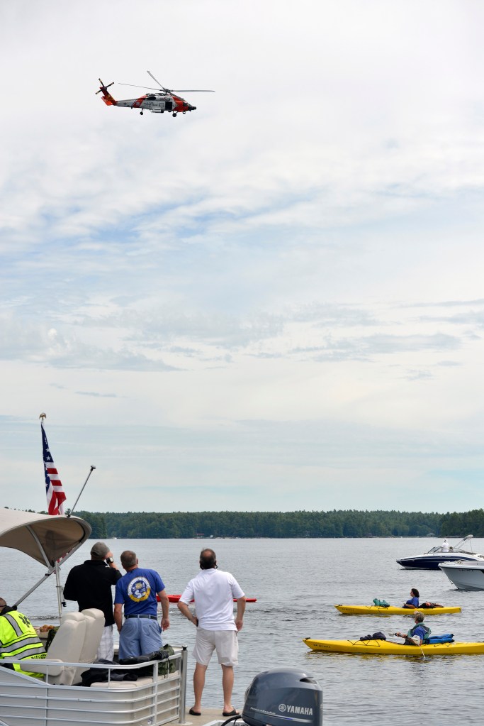 A United States Coast Guard helicopter from Cape Cod flies over Sebago Lake in Standish as four Navy SEALs swim 13.5 miles to raise money for Camp Sunshine in Casco on Thursday.