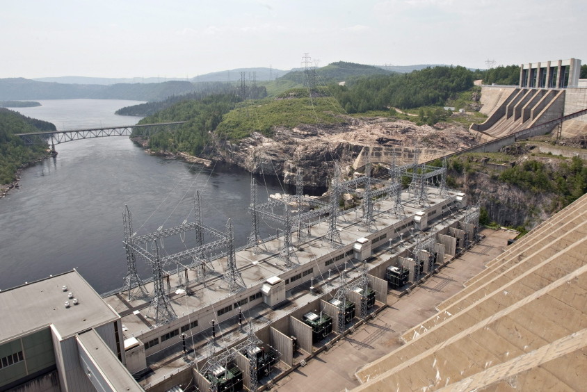 In this June 2010 photo, the Jean-Lesage hydro electric dam generates power along the Manicouagan River north of Baie-Comeau Quebec. Critics of proposals to import relatively clean hydropower from Quebec into the Northeastern United States worry that transmission lines will despoil the natural beauty of places like New Hampshire’s White Mountains. Others fear over-reliance on it will stymie efforts to trim consumption and develop renewable energy sources closer to home.