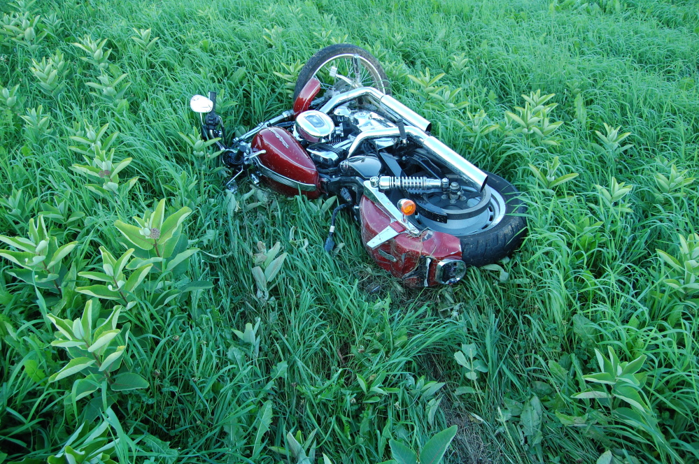 The Harley-Davidson ridden by Jonathan Billings, of Windham, Sunday lies in a field in New Sharon where Billings crashed. Billings, 24, was killed in the accident, one of four motorcyclist deaths in the state over the weekend and 17 since the beginning of the year. There were six road fatalities in all in Maine between Friday and Sunday.