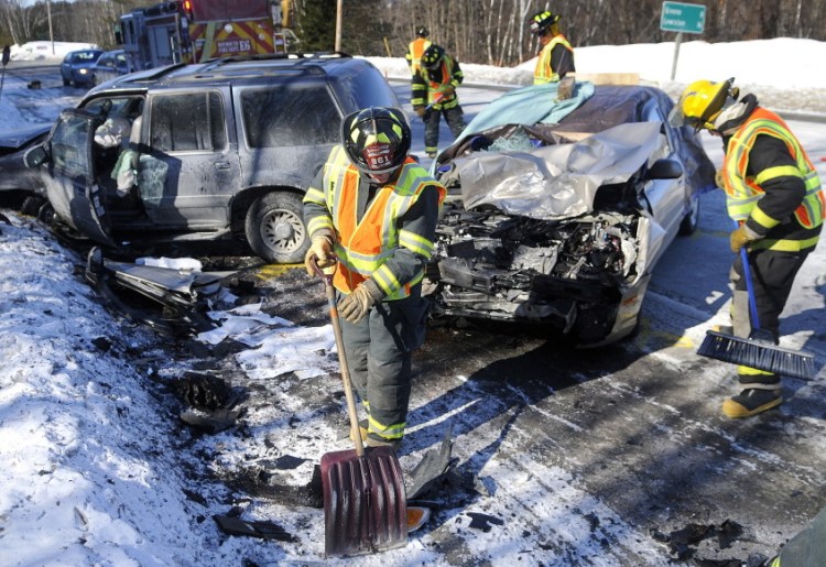 Monmouth firefighters collect debris from a two car collision that killed a woman last year on Route 202 in Monmouth.