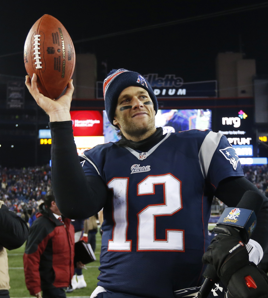 AP photo 
 In this Jan. 10 photo, Patriots quarterback Tom Brady holds up the game ball after a divisional playoff game against the Ravens in Foxborough, Mass. The Ravens deny they tipped off the Indianapolis Colts about underinflated footballs before the AFC championship game.