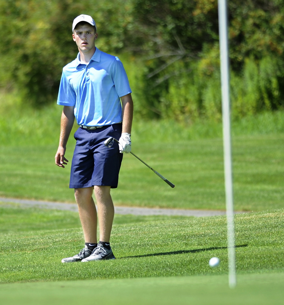 Carter Pearl of Newport watches as his chip shot almost goes in on the 13th hole during the first day of Maine Junior Golf Championship at Toddy Brook Golf course in North Yarmouth.