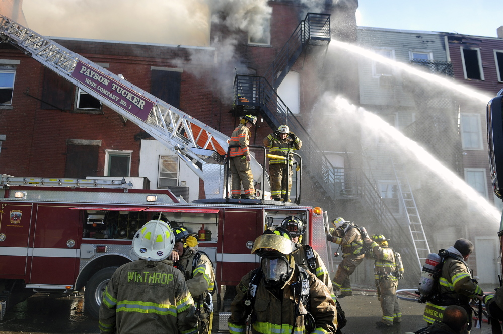 Firefighters exit the exterior of one of the buildings on Water Street in Gardiner that sustained extensive damage July 16.