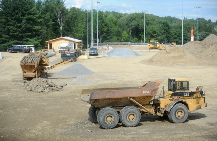 Construction crews work on the new baseball and softball complex Thursday at Colby College in Waterville.