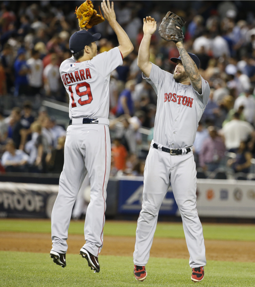 Boston Red Sox first baseman Mike Napoli, right, was traded Friday to the Texas Rangers for a player to be named later or cash.