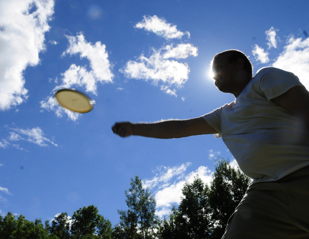 Nick Boulette takes a practice toss on the driving range before league play at DND Disc Golf on Thursday in Sidney.