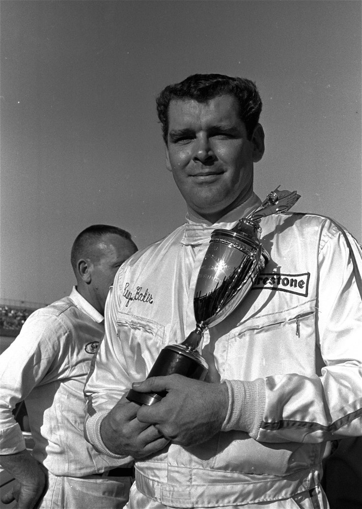 In this Feb. 9, 1969, file photo, Buddy Baker  holds a trophy presented to him after he won the pole position for the Daytona 500 Grand National stock car race at Daytona Speedway in Daytona Beach, Fla.