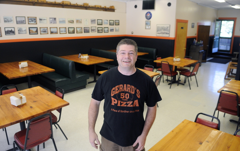 Gerard’s Pizza proprietor Jeff McCormick reopened the business Monday after a July 16 fire at neighboring buildings on Water Street.