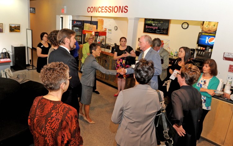 Jane Chu, chairman of the National Endowment of the Arts, left center, is greeted in the lobby of Railroad Square cinemas during a special meeting with local arts groups in Waterville on Tuesday.