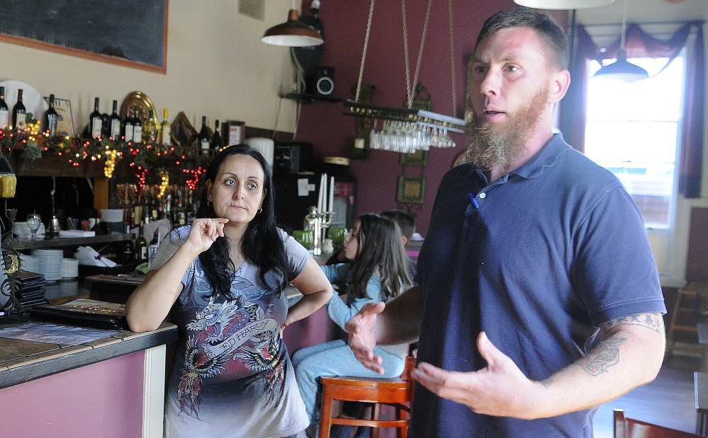 Jason McFarland discusses with his wife, Helena Gagliano-McFarland, on Wednesday in Augusta measures that must be taken to reopen the Water Street restaurant Gagliano’s Italian Bistro.