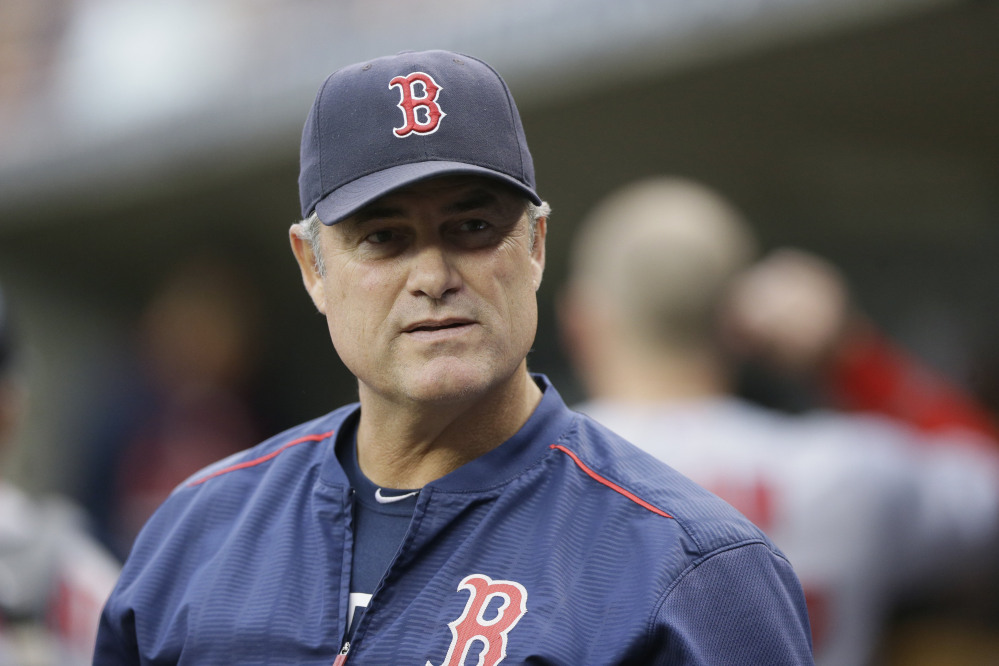 Boston Red Sox manager John Farrell watches from the dugout during the first inning of a game against the Detroit Tigers in Detroit last Saturday. Farrell said Friday he has lymphoma and is stepping away from the team.