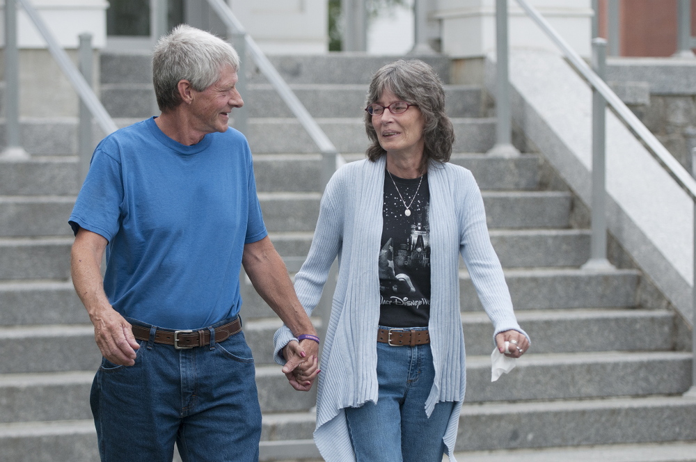 Vance Ginn, left, and his wife, Angel Ginn, leave Piscataquis County Superior Court on Wednesday in Dover-Foxcroft after attending Robert Burton’s initial court appearance. Burton is charged with being a fugitive from justice and is a suspect in the June 5 slaying of Stephanie Gebo, 37, who was found dead inside her Parkman home by her two children. Vance is Stephanie Gebo’s father.