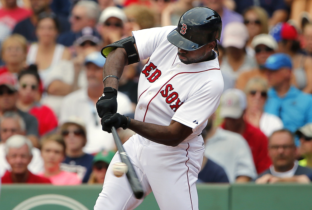 Boston Red Sox’s Jackie Bradley Jr. connects on a two-run double against the Seattle Mariners during the seventh inning of Saturday’s game at Fenway Park in Boston. Bradley Jr. finished with two home runs, three doubles and seven RBIs as the Red Sox rolled the Mariners 22-10.