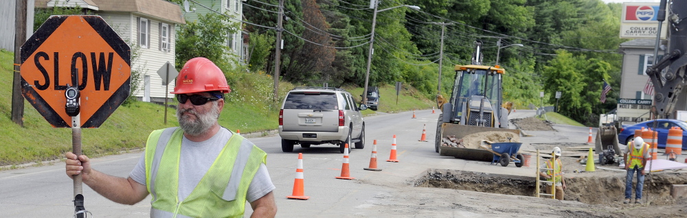 Flagger Wayne Stuart slows traffic Thursday on Mount Vernon Avenue in Augusta. Starting Monday, all drivers need to know that a section of the major thoroughfare will be one-way heading north, and they should seek alternate routes.