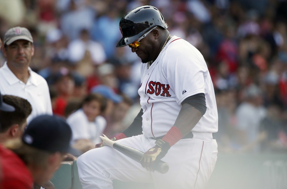 Boston Red Sox designated hitter David Ortiz breaks his bat over his knee after striking out during the eleventh inning against the Seattle Mariners on Sunday in Boston. The Mariners won 10-8.