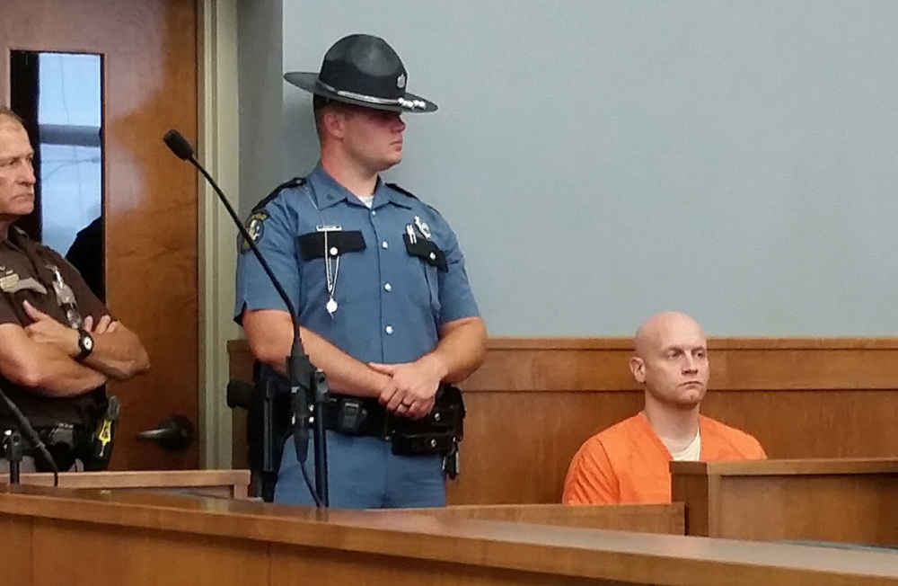 Robert Burton waits to be returned to his cell at Piscataquis County Superior Court at his initial court hearing last week.