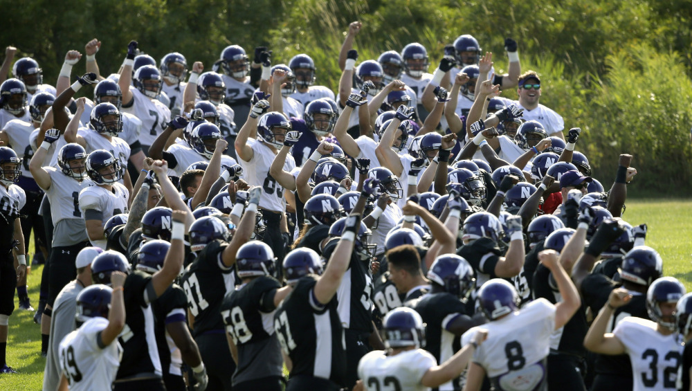 Northwestern football players gesture during practice at the University of Wisconsin-Parkside campus on Monday, in Kenosha, Wi. The National Labor Relations Board overturned a historic ruling that gave Northwestern University football players the go-ahead to form the nation’s first college athletes’ union, saying the prospect of union and non-union teams could throw off the competitive balance in college football.