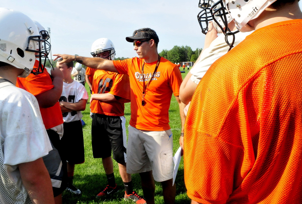 Skowhegan Area High School head football coach Matt Friedman talks to his players during practice Monday in Skowhegan.