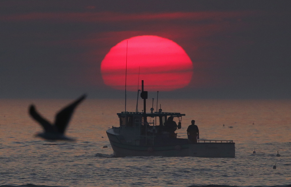 A lobster boat heads out to sea at sunrise, off Kennebunkport.