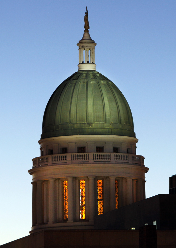 AP file photo by Robert F. Bukaty
In this photo from Oct. 28, 2011, the old copper dome of the State House had a green hue after a century of exposure to the weather. Some of the old copper may be available to the public as soon as next month and plans are underway to construct a sculpture with the copper somewhere on the capitol grounds in Augusta.