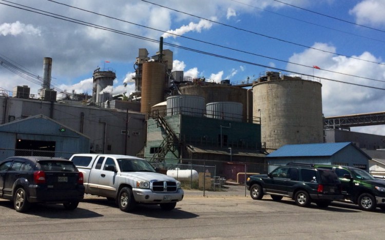 Workers’ cars line the parking lot of the Androscoggin Mill in Jay Thursday. Verso, the company that owns the mill, announced earlier in the day that it will lay off 300 workers before the year is over.