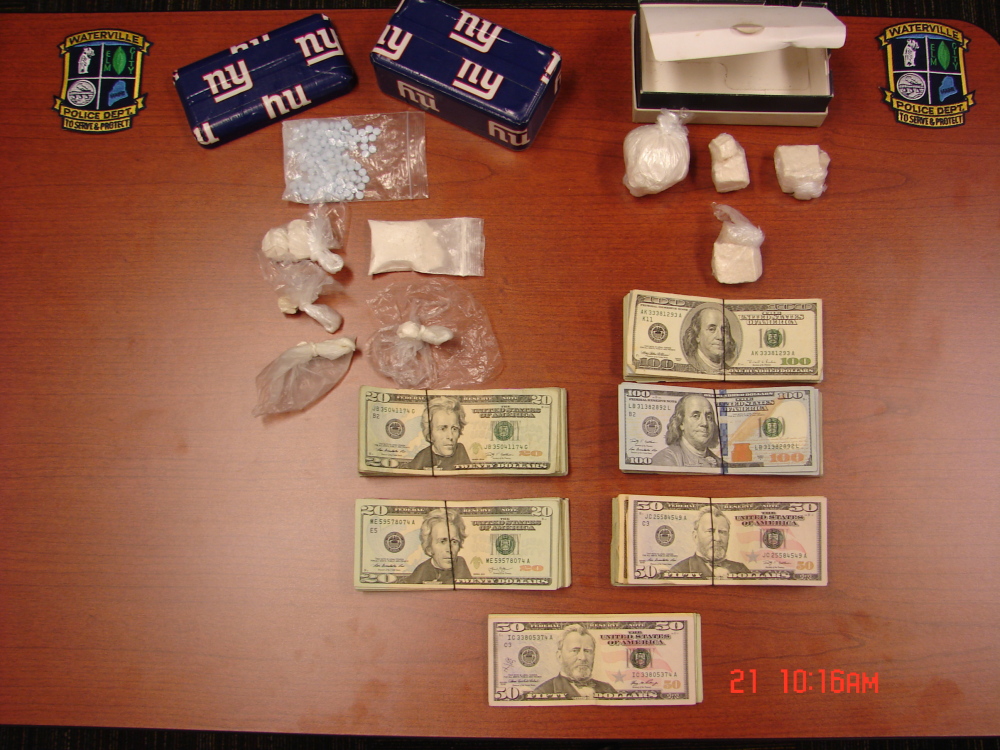 Cash and drugs taken in an apartment raid by Waterville police Friday are displayed at the police department Friday afternoon. Brian Danaher of Sherwin Street is charged with multiple drug-related counts.