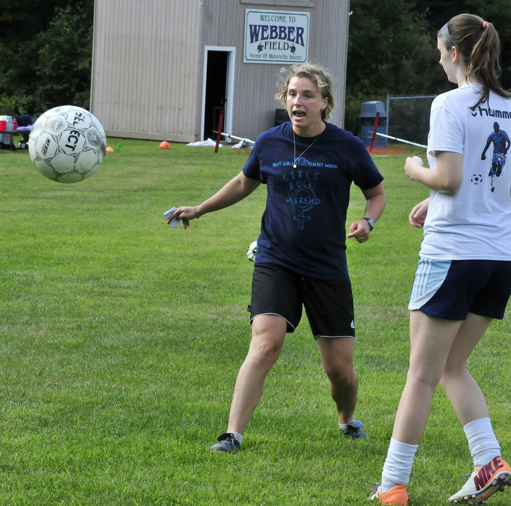 Staff photo by David Leaming 
 New Waterville girls soccer coach Christine Bright leads a drill during practice Thursday at Webber Field.