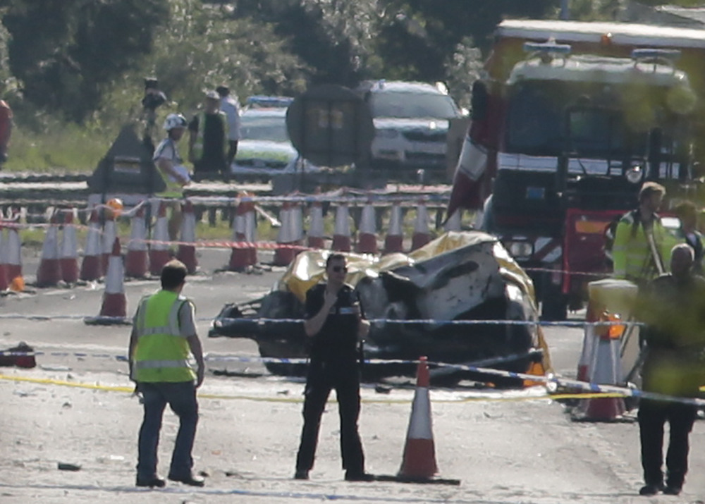 Emergency services attend the scene on the A27 after a plane crashed into cars on the major road during an aerial display at the Shoreham Airshow in West Sussex, England, on Saturday.