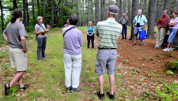 Maine Master Naturalist Kate Drummond, second from left, leads a group on an informational hike along a trail in the Pines area in Madison on Sunday. The event was part of the Madison-Anson Days celebration.