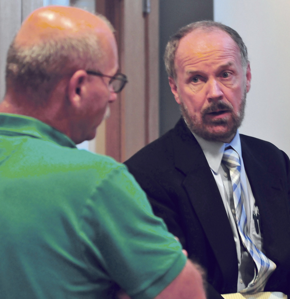 Attorney Bill Lee, right, speaks with Fairfield Fire Chief Duane Bickford following a brief hearing with Robert Dale in Skowhegan District Court on Monday.