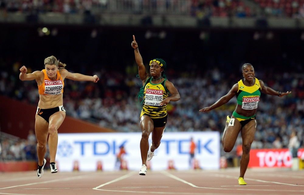 AP photo 
 Jamaica's Shelly-Ann Fraser-Pryce, middle, celebrates after winning the women’s 100-meter final at the World Athletics Championships at the Bird's Nest stadium in Beijing on Monday. Dafne Schippers of the Netherlands, left, finished second. Jamaica's Veronica Campbell-Brown is at right.