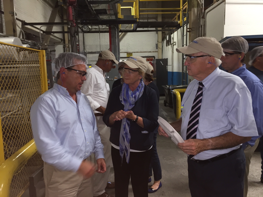 U.S. Rep. Chellie Pingree, D-1st District, and USDA Under Secretary for Food and Nutrition Kevin Concannon, right, talk to Michael Wadsworth, production manager at Huhtamaki plant, during a tour Monday. The Waterville fiber manufacturer is supplying compostable lunch plates to six of the nation’s largest school districts.