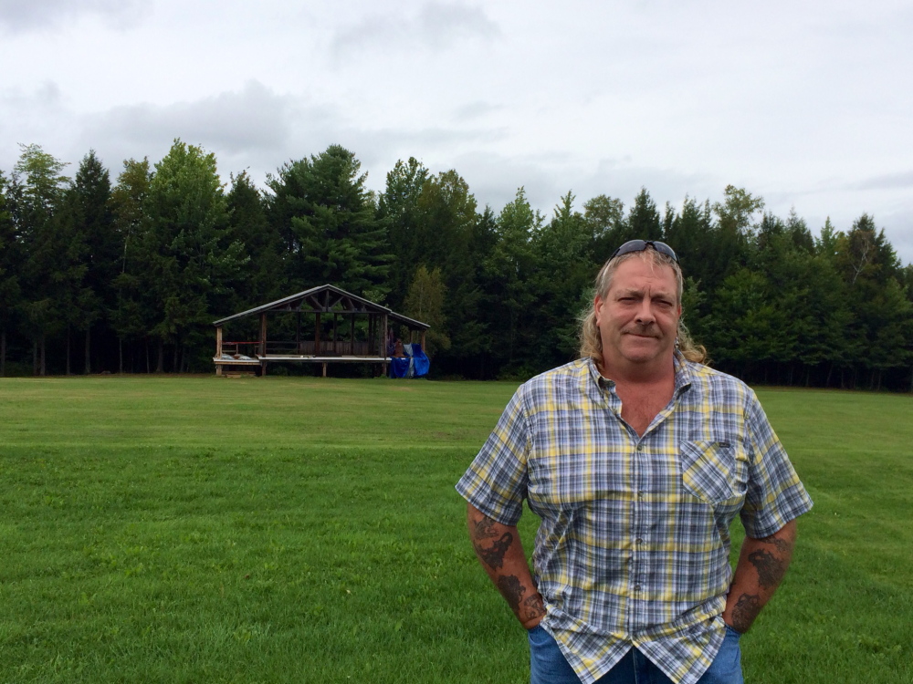 Tim Rogers, ninth-generation owner of Last Breath Farm, stands in front of what will be the main stage at the Great North Music and Arts Festival.