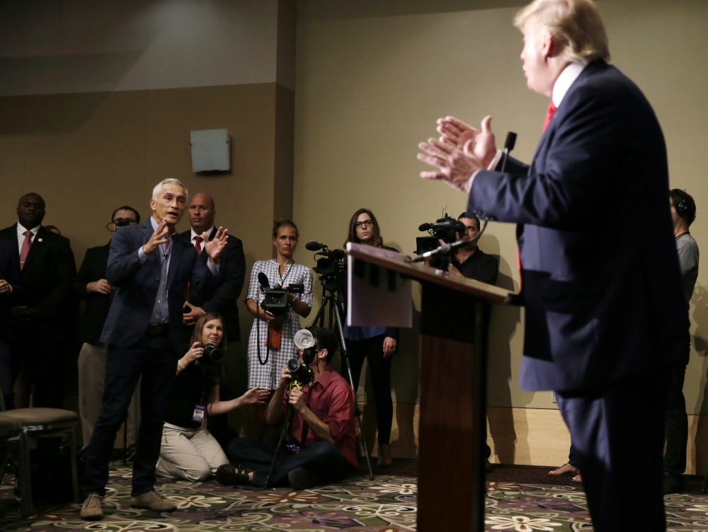 Miami-based Univision anchor Jorge Ramos, left, asks Republican presidential candidate Donald Trump a question about his immigration proposal during a news conference, Tuesday, in Dubuque, Iowa.