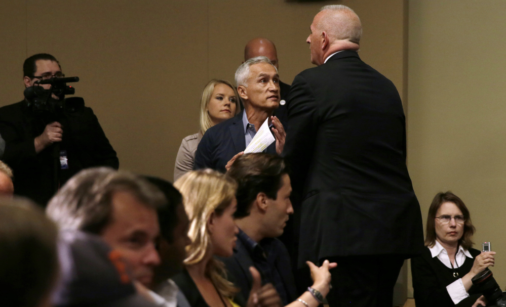 A security guard for Republican presidential candidate Donald Trump removes Miami-based Univision anchor Jorge Ramos from a news conference, Tuesday in Dubuque, Iowa.